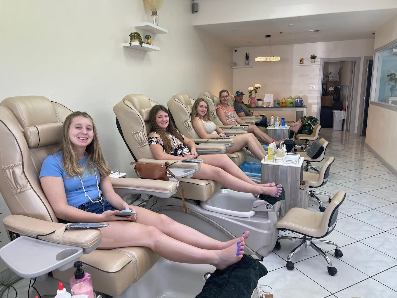 Clients relaxing in Best Nails Spa's comfortable pedicure chairs