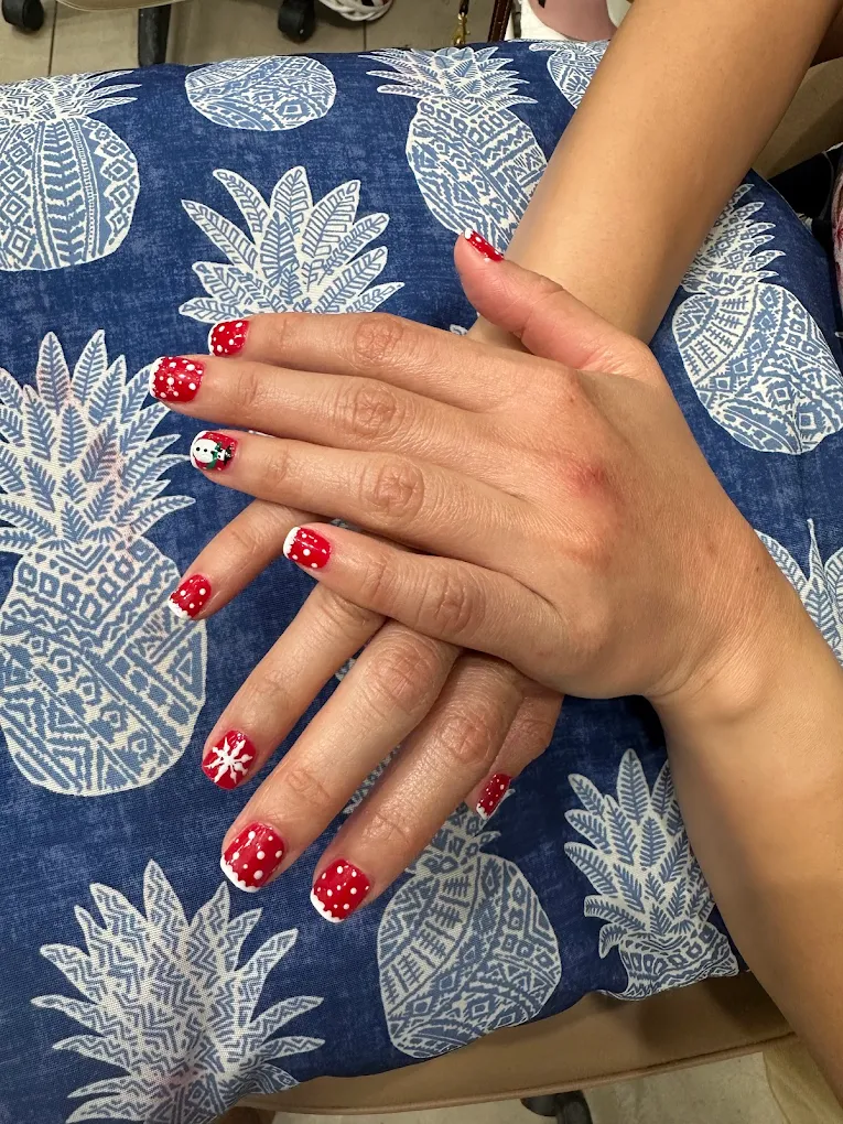 Red festive nails with polka dots and snowflakes